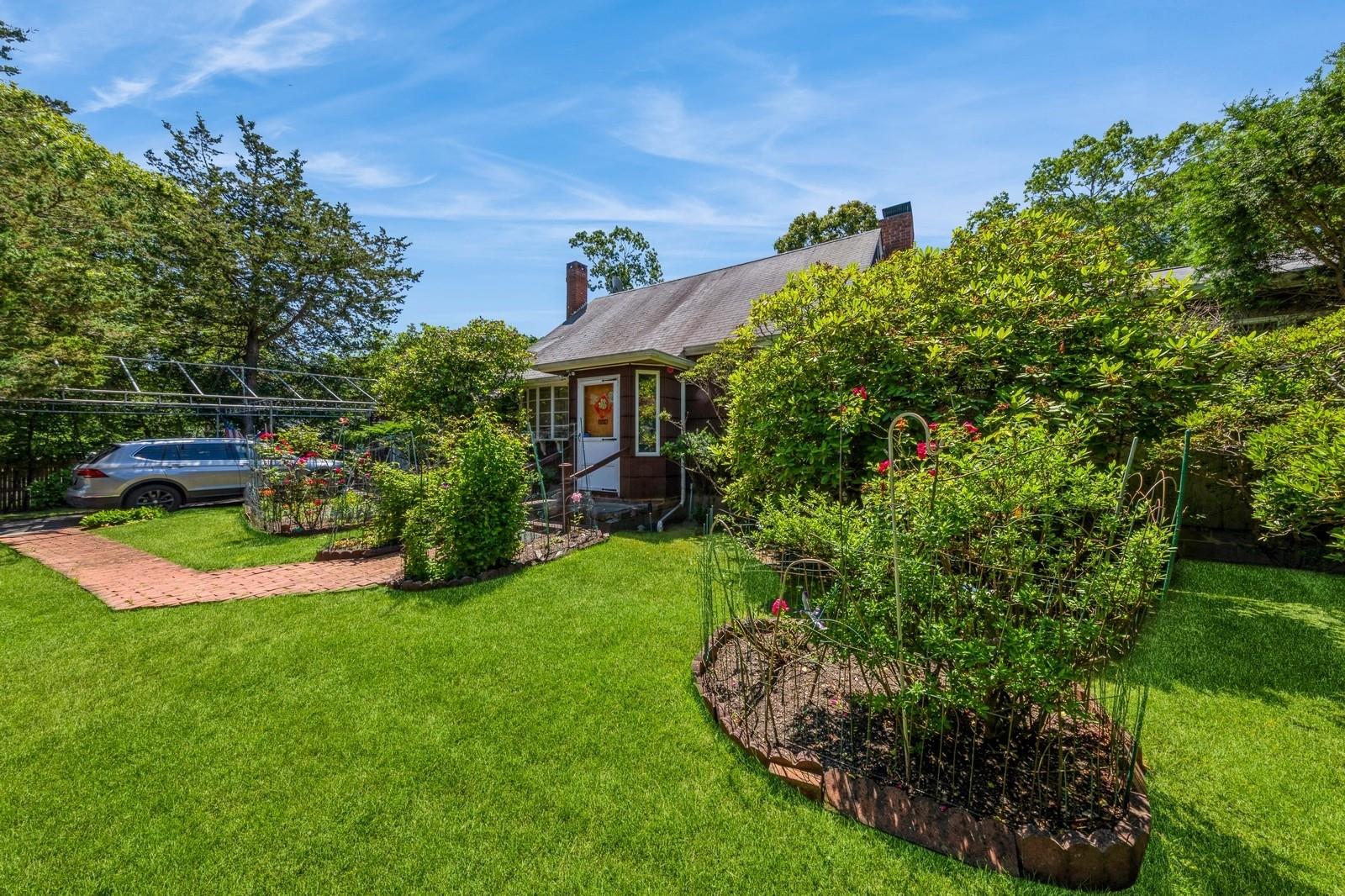 a view of a house with a garden and plants