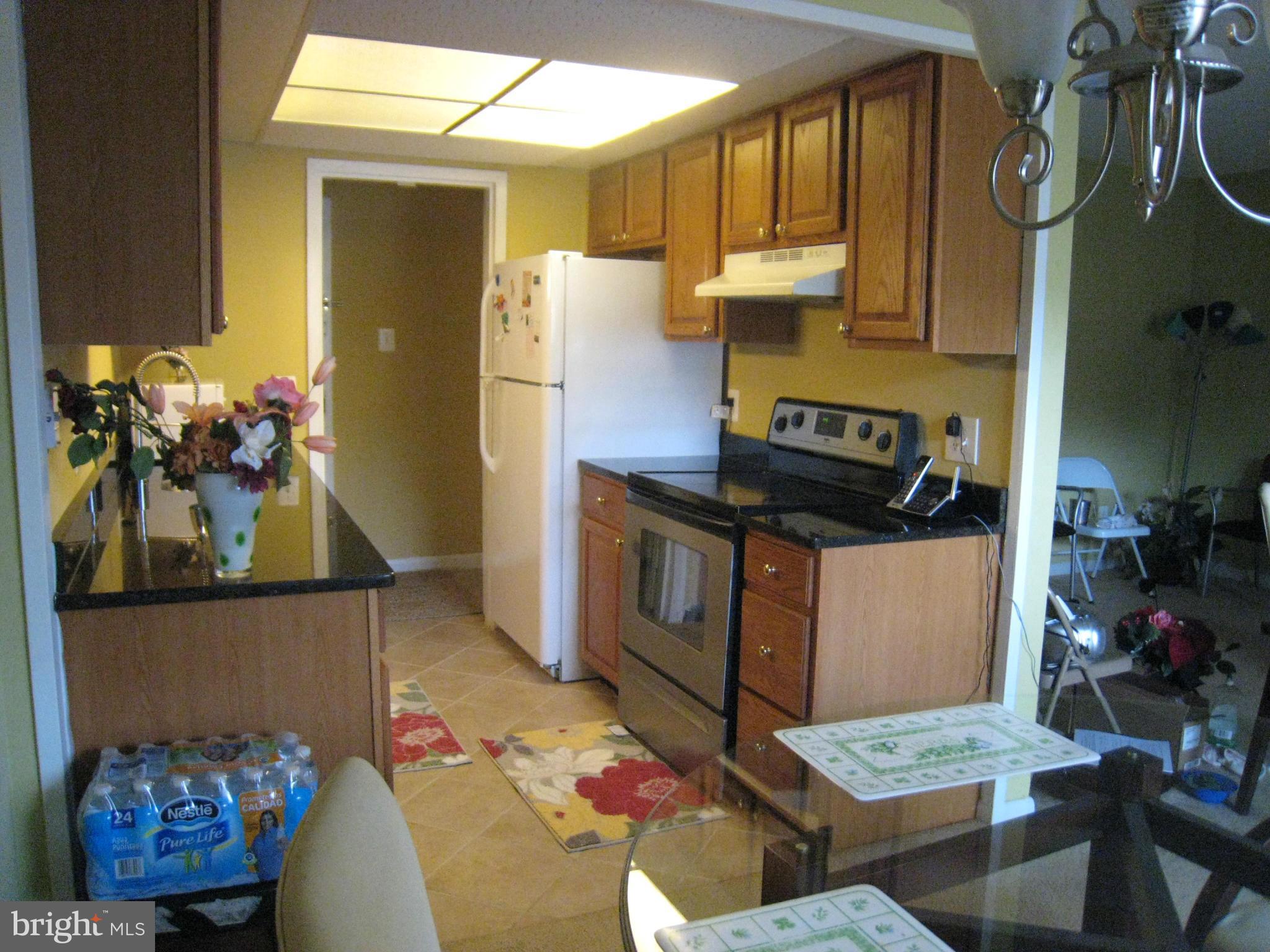 2234 Castle Rock Square, Unit 11C Reston, VA 20191 - Photo 2 of 30 a kitchen with stainless steel appliances granite countertop a stove a sink and a refrigerator