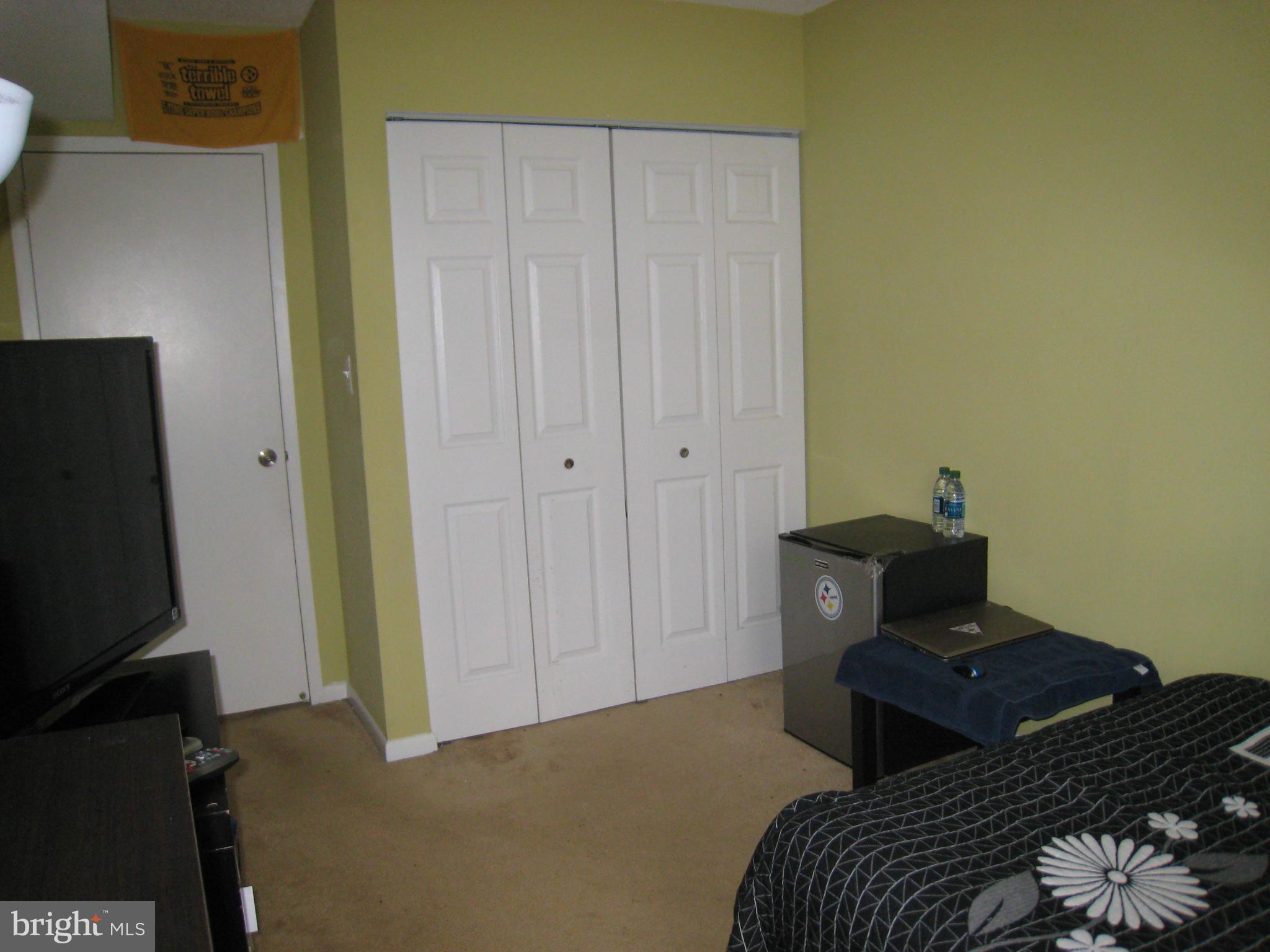 2234 Castle Rock Square, Unit 11C Reston, VA 20191 - Photo 21 of 30 a bedroom with a bed and a tv