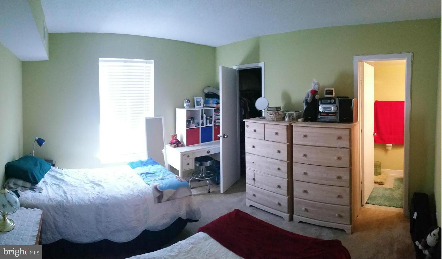 2234 Castle Rock Square, Unit 11C Reston, VA 20191 - Photo 23 of 30 a bedroom with a bed and furniture