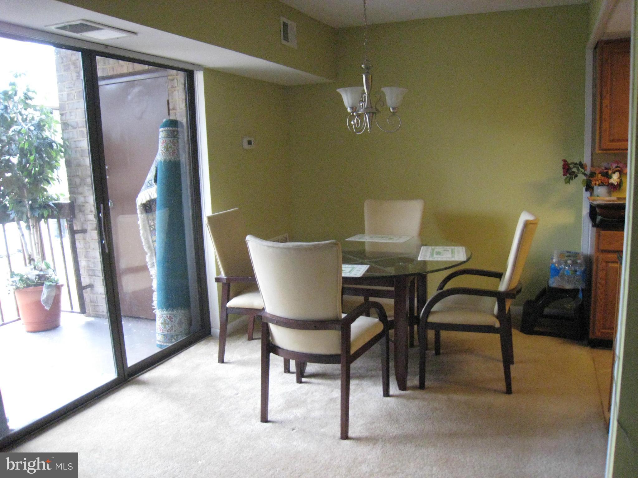 2234 Castle Rock Square, Unit 11C Reston, VA 20191 - Photo 8 of 30 a view of a dining room with furniture and a potted plant