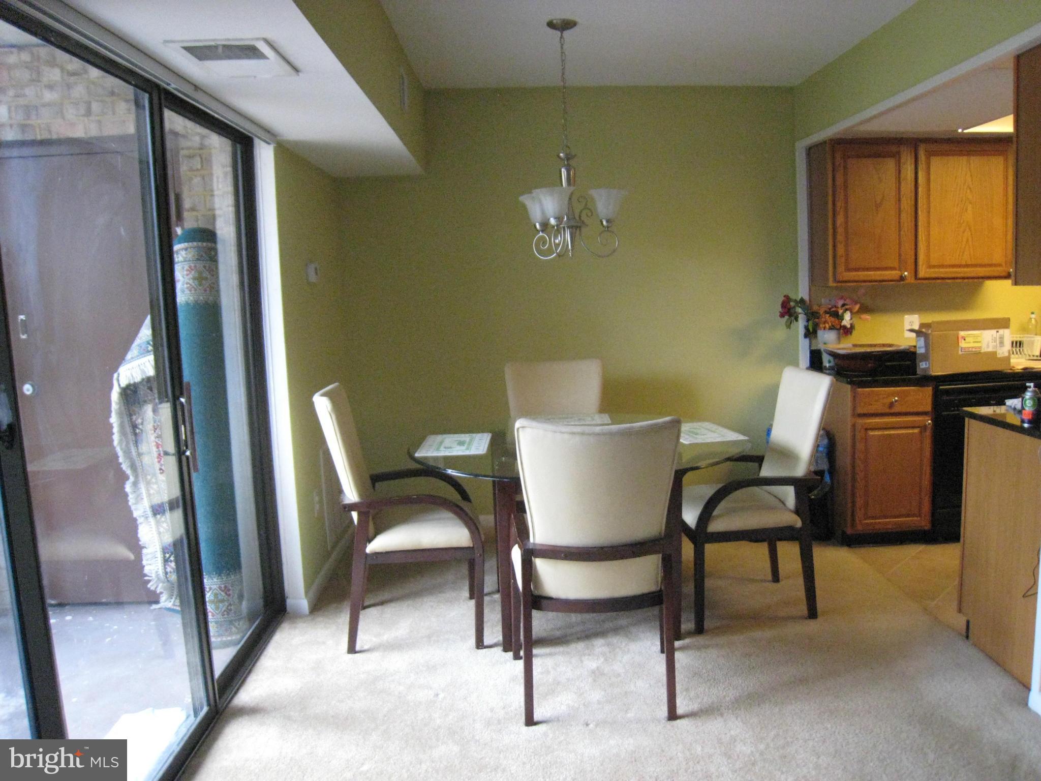 2234 Castle Rock Square, Unit 11C Reston, VA 20191 - Photo 9 of 30 a view of a dining room with furniture and a chandelier