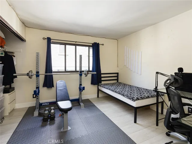 a bedroom with furniture and a window