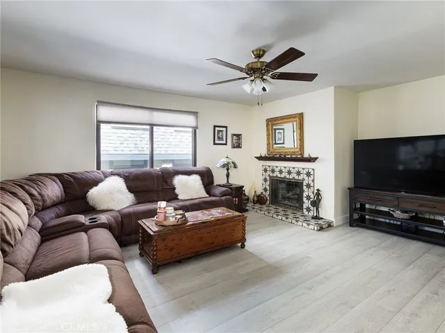 a living room with furniture a flat screen tv and a fireplace