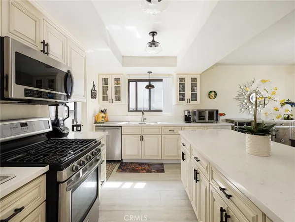 a kitchen with a sink stove and microwave