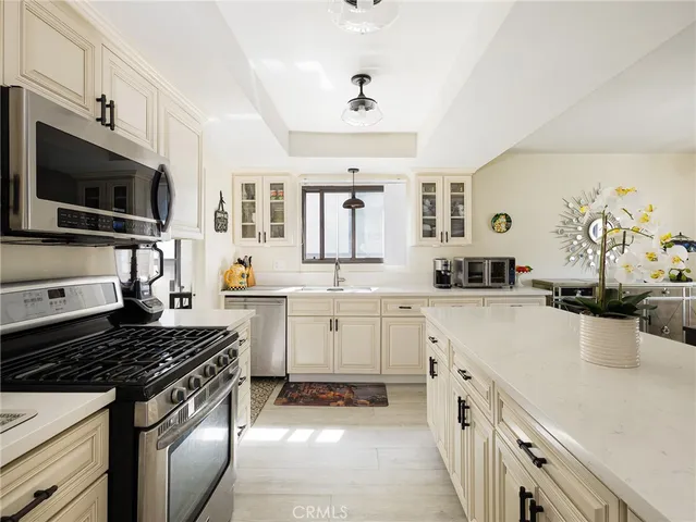 a kitchen with a sink stove and microwave