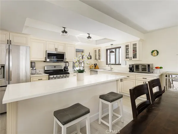 a kitchen with stainless steel appliances a sink and a refrigerator