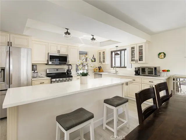 a kitchen with stainless steel appliances a sink and a refrigerator