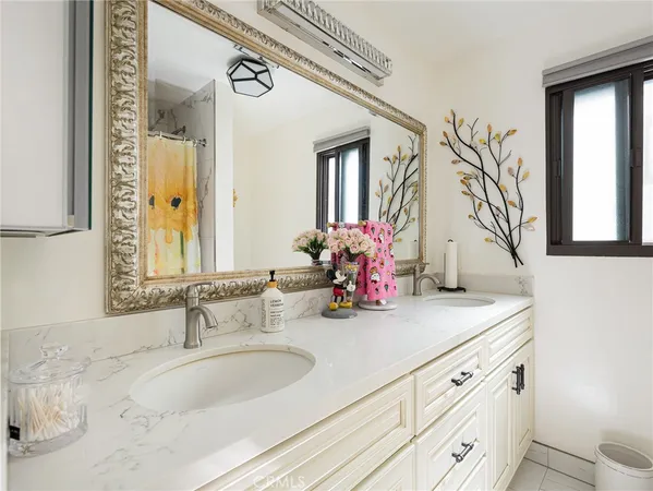a bathroom with a sink double vanity and a mirror