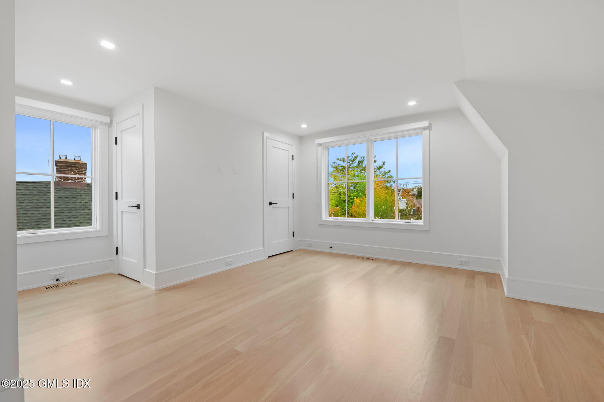 187 Field Point Road, Unit A Greenwich, CT 06830 - Photo 19 of 32 an empty room with windows and entrance