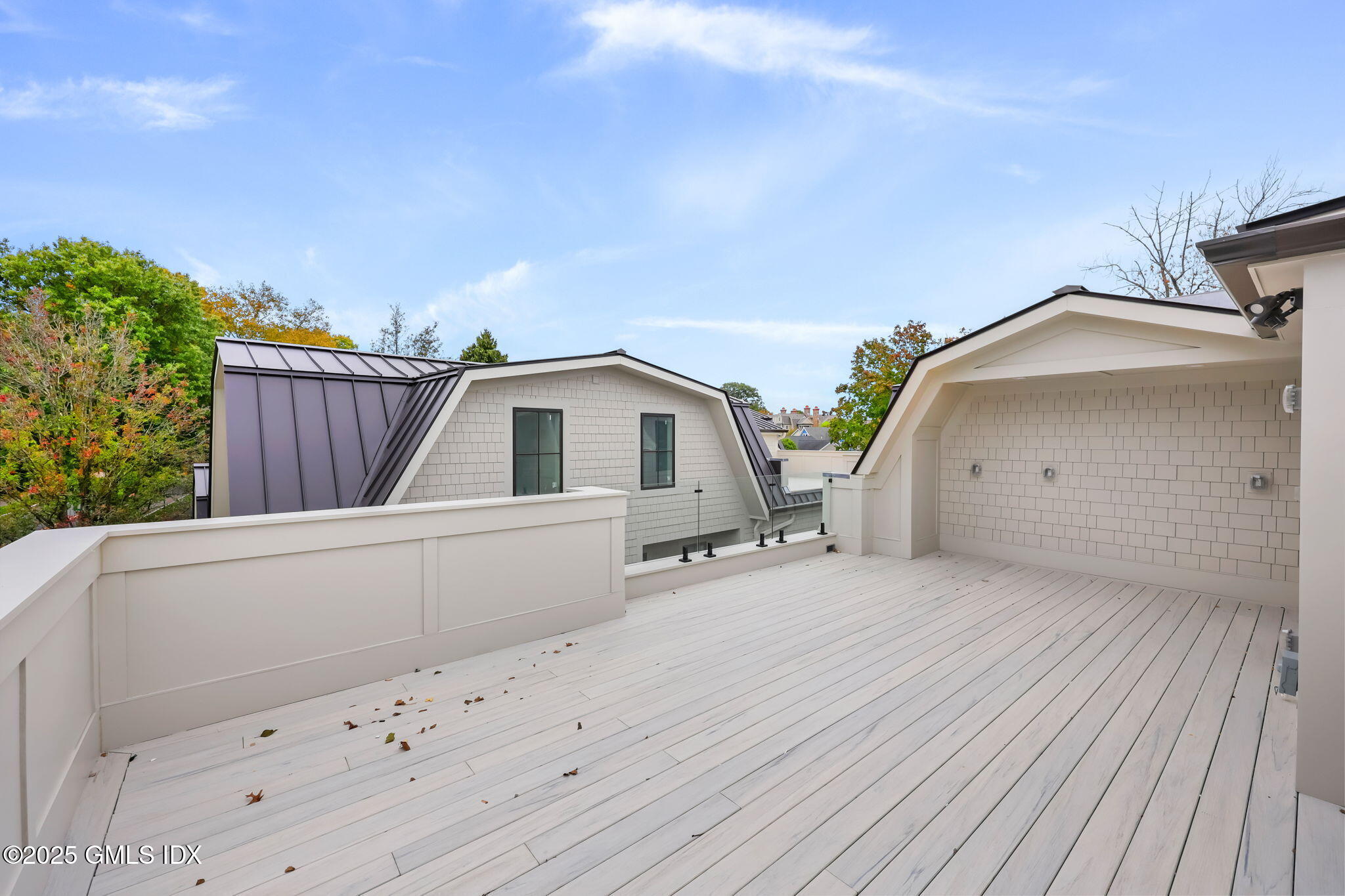 187 Field Point Road, Unit A Greenwich, CT 06830 - Photo 21 of 32 a view of a wooden house with a wooden fence
