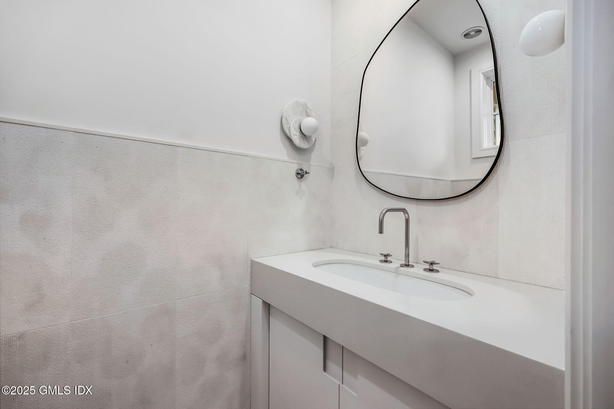 187 Field Point Road, Unit A Greenwich, CT 06830 - Photo 9 of 32 a bathroom with a sink and mirror