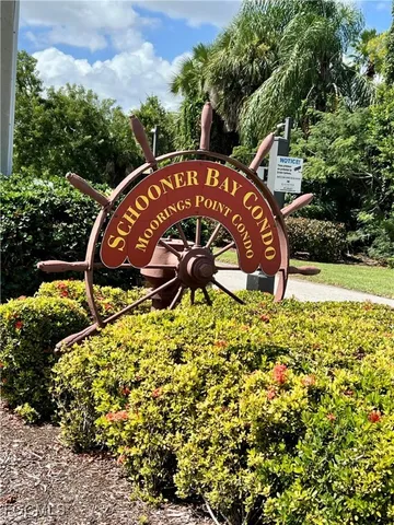 a view of a garden with a bench under an umbrella