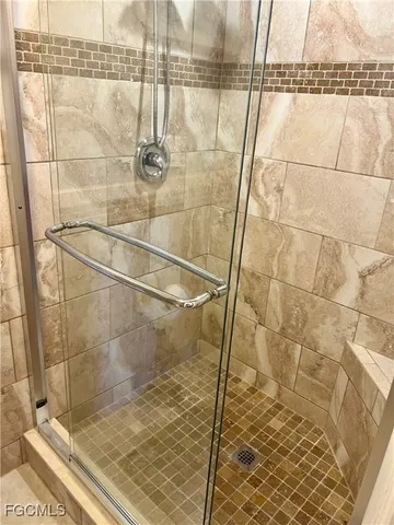 a bathroom with a sink a mirror and shower
