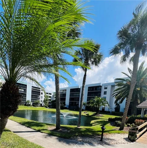 a view of a house with swimming pool and a small yard