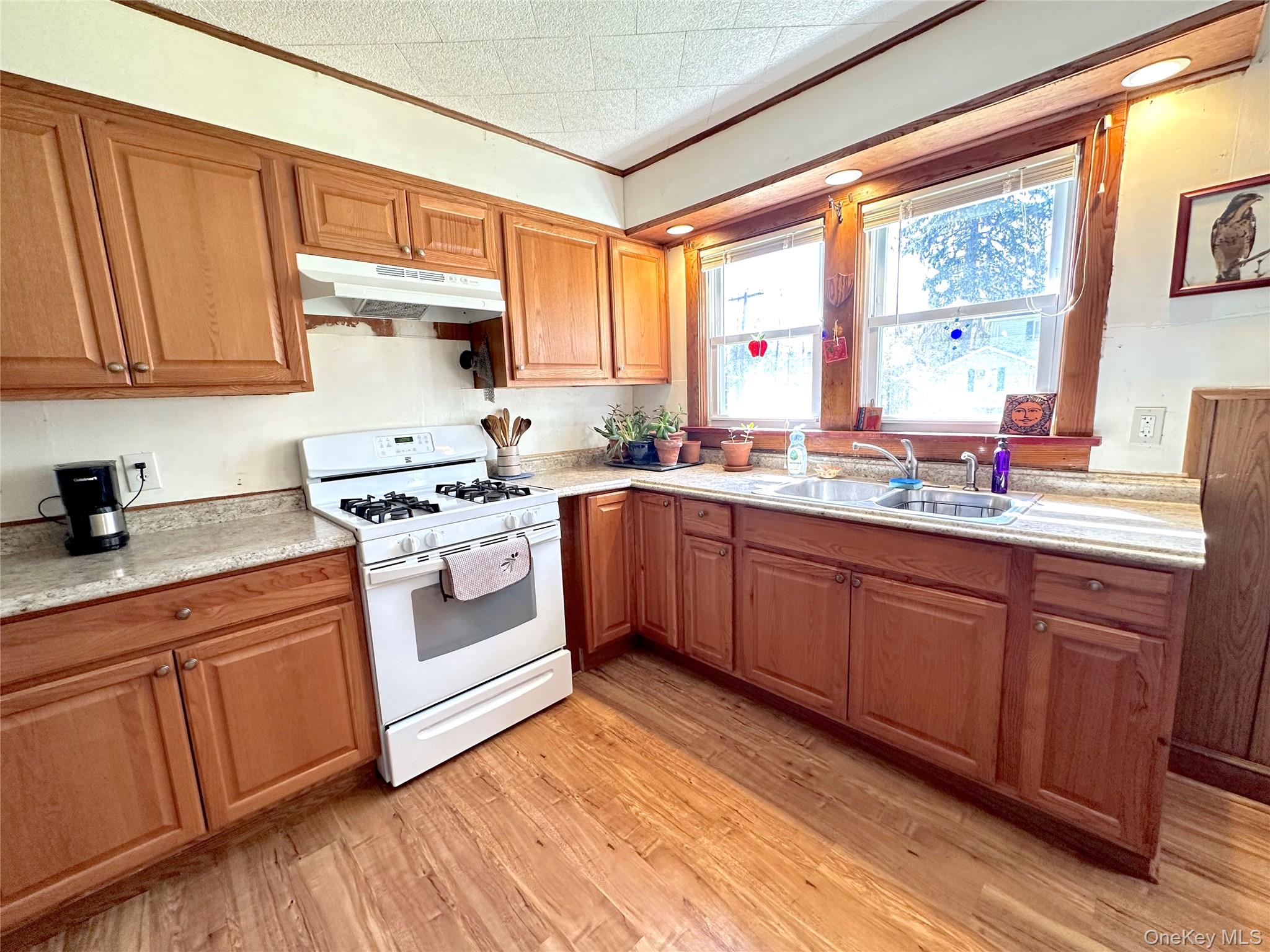 10 Upper Ferndale Road Liberty, NY 12754 - Photo 15 of 30 a kitchen with stainless steel appliances sink a stove and white refrigerator with wooden cabinets