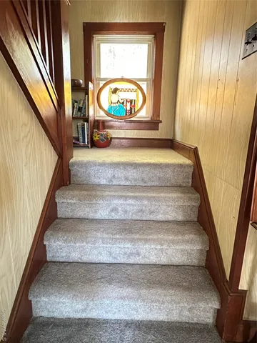 a view of a porch with a door and wooden floor