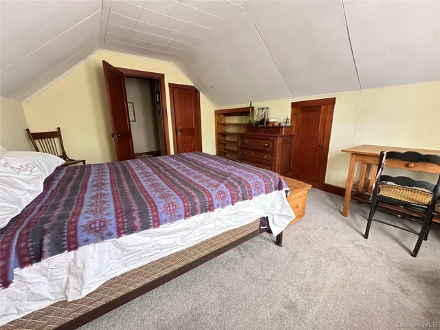a view of a patio with table and chairs with wooden floor and fence