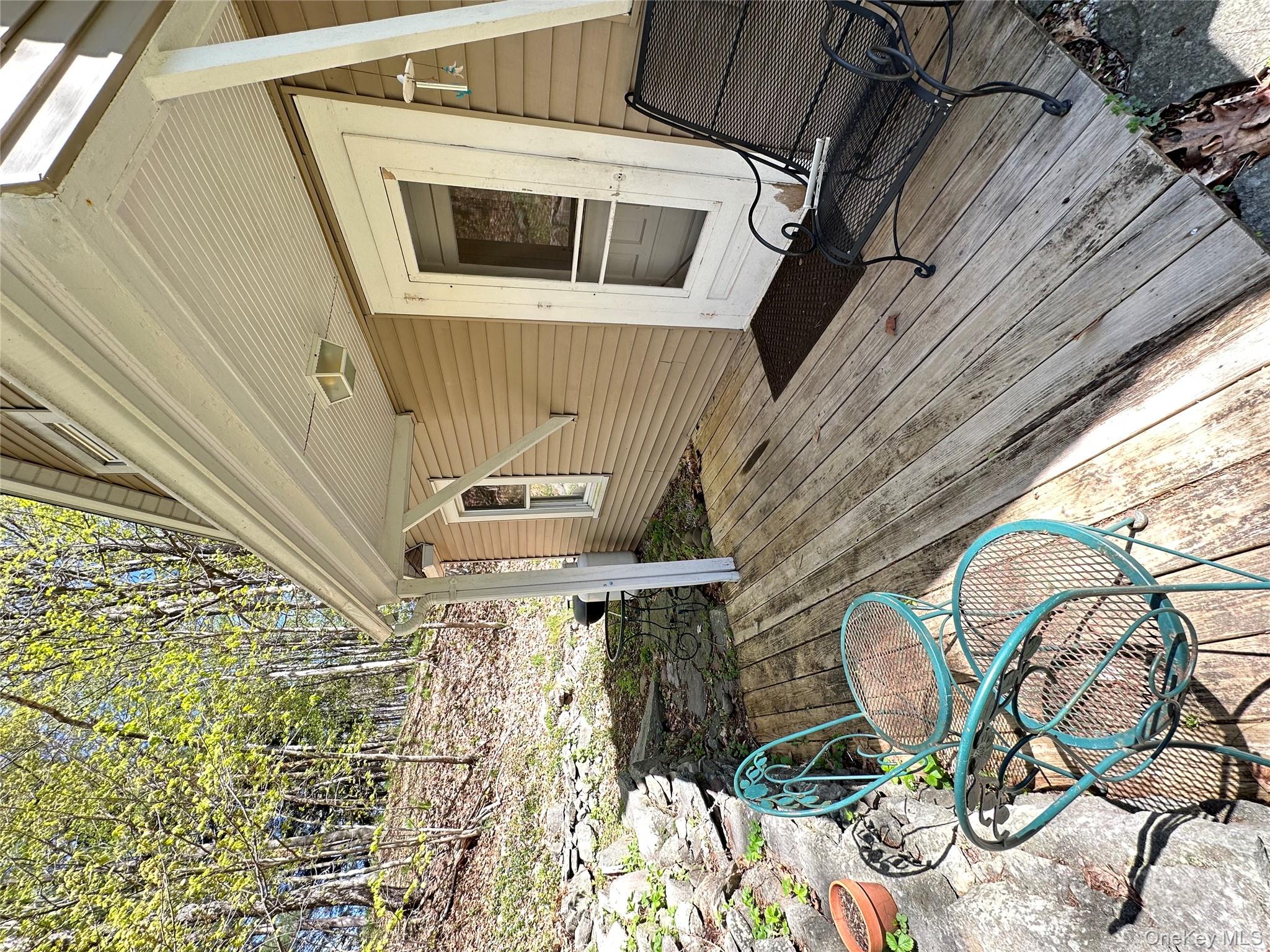 10 Upper Ferndale Road Liberty, NY 12754 - Photo 26 of 30 a view of a patio with table and chairs with wooden floor and fence