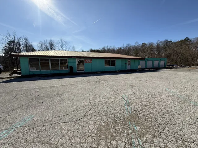 a front view of house with yard and trees around