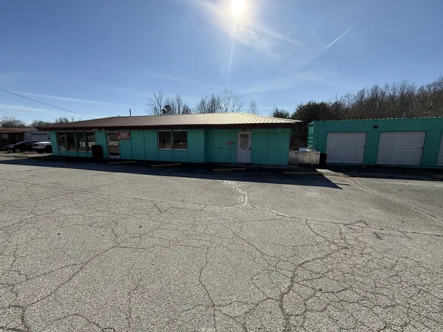 a view of a yard with wooden fence