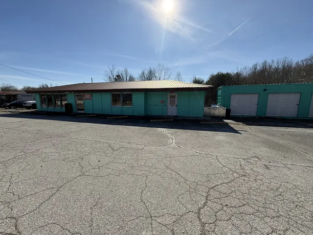 a gym room with furniture and a flat screen tv