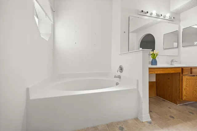 a bathroom with a bathtub and a sink