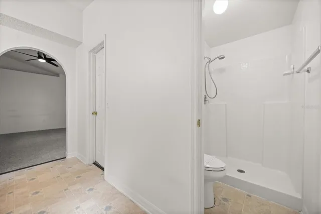 a bathroom with a toilet and shower