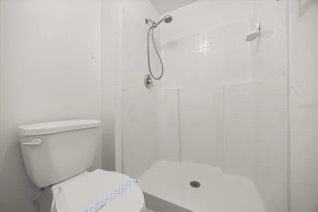 a bathroom with a toilet and shower