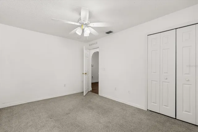 an empty room with fan and fan