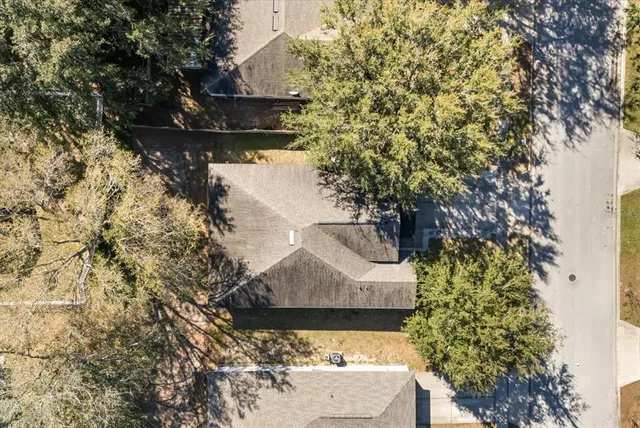 an aerial view of a house with a yard