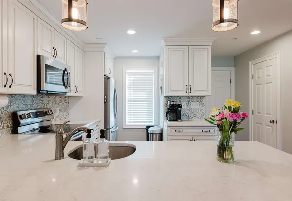 a view of a dining room with furniture wooden floor and chandelier