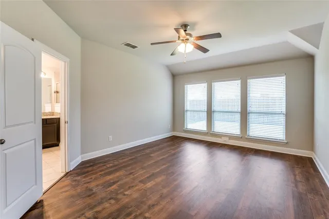 a view of wooden floor and windows in a room