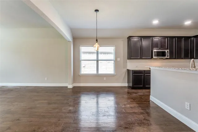 a view of a kitchen with a sink and a fireplace