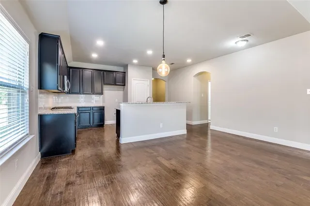 a view of a kitchen with a sink cabinets and wooden floor