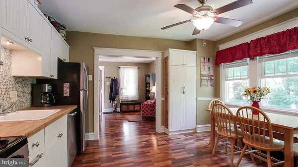 a view of a dining room with furniture window and wooden floor