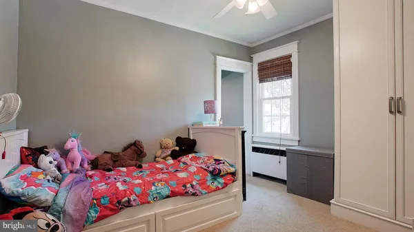 a bedroom with bed and window
