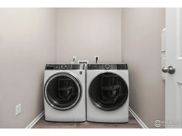 a bathroom with a granite countertop sink a light fixture and a mirror