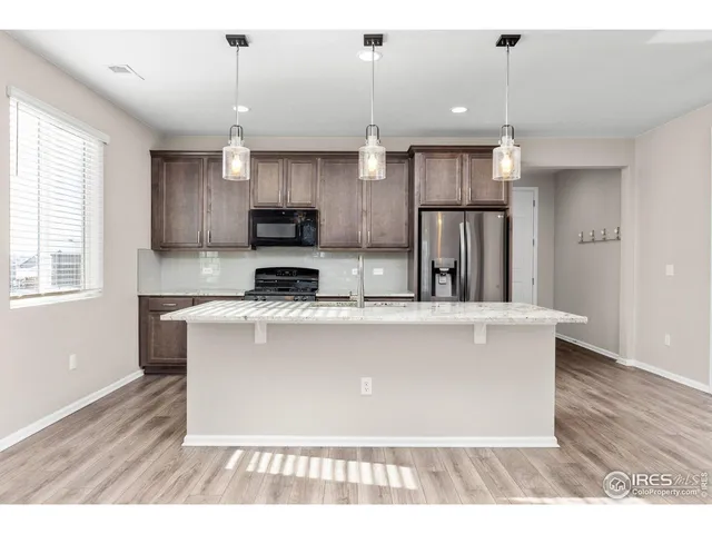 a kitchen with a sink cabinets and wooden floor
