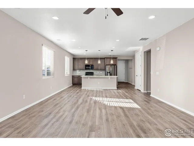 a kitchen with stainless steel appliances granite countertop a stove microwave and refrigerator