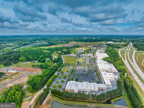 an aerial view of a residential houses with outdoor space and river view