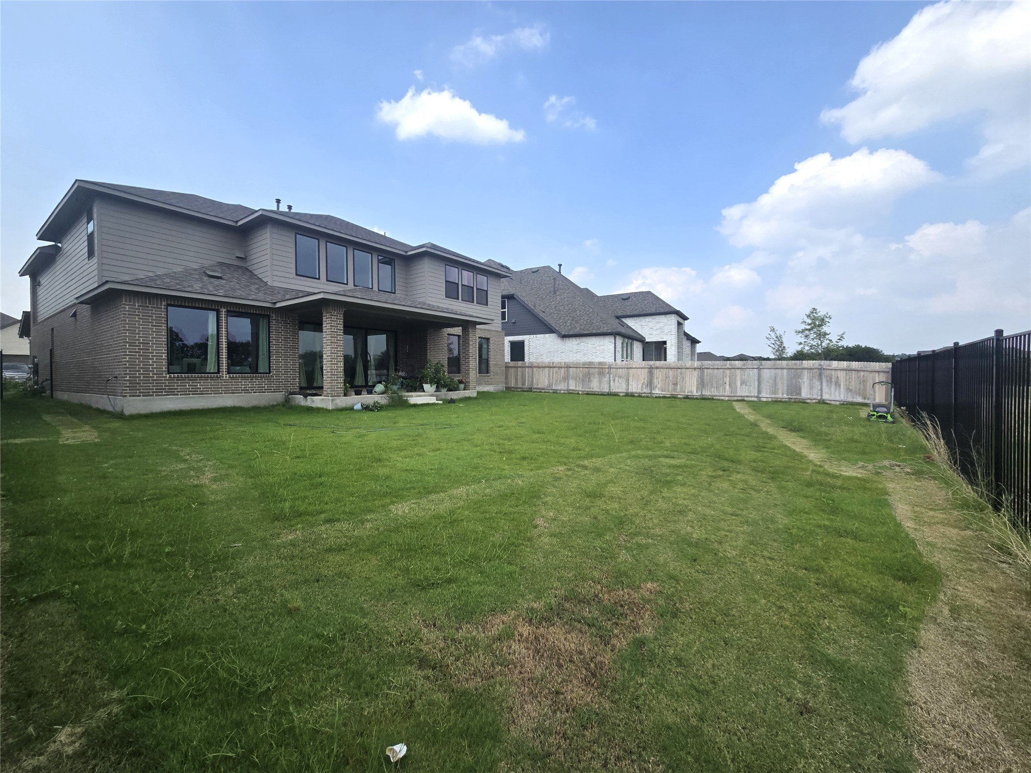 124 Ribera Drive Liberty Hill, TX 78642 - Photo 30 of 40 A spacious lawn provides ample outdoor living space behind this charming two-story residence.