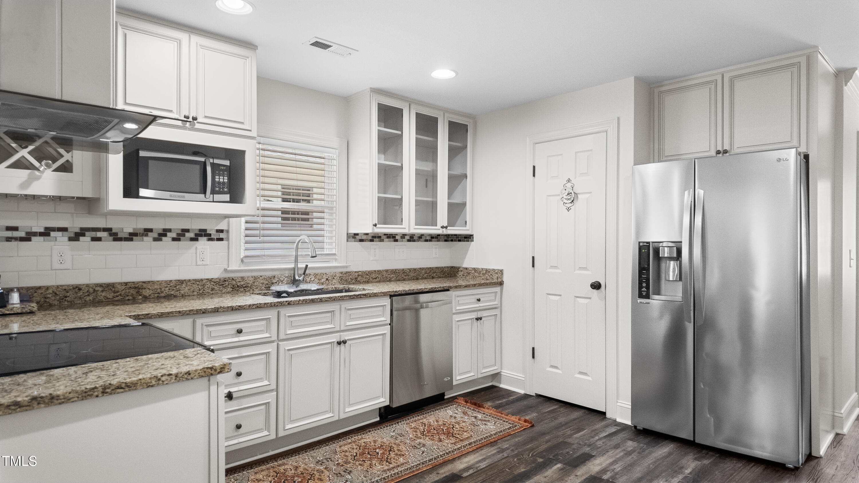 304 Spring Street Durham, NC 27703 - Photo 6 of 28 The kitchen is a true highlight with sleek countertops, tons of cabinet space, stainless steel appliances, and a stylish, elegant extractor.