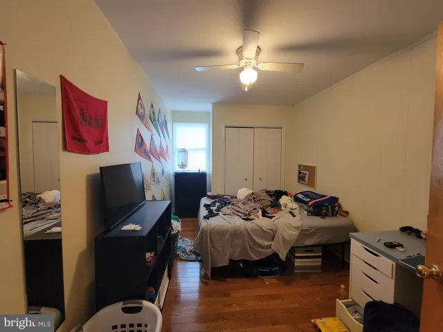 a bedroom with bed and a chandelier