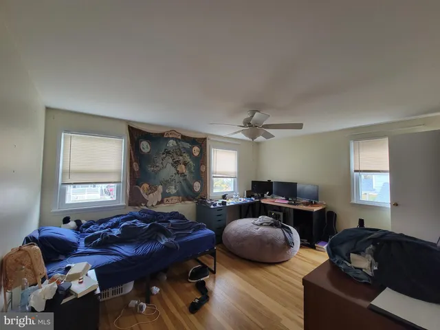 a living room with furniture ceiling fan and a window