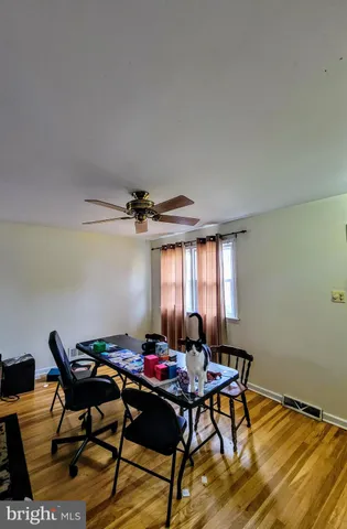 a view of a workspace with furniture window and wooden floor