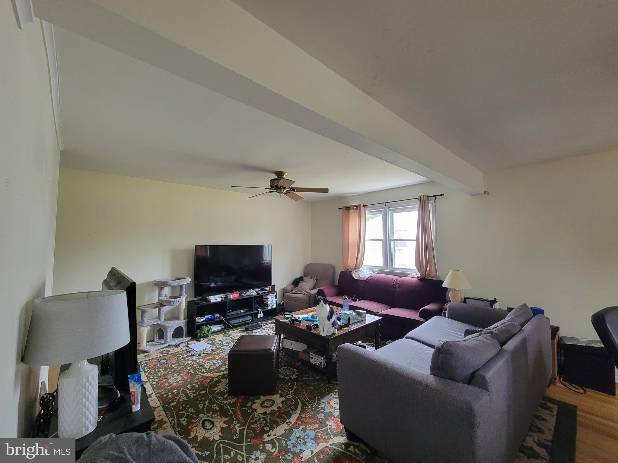 212 Cornell Road Glassboro, NJ 08028 - Photo 6 of 19 a living room with furniture and a flat screen tv