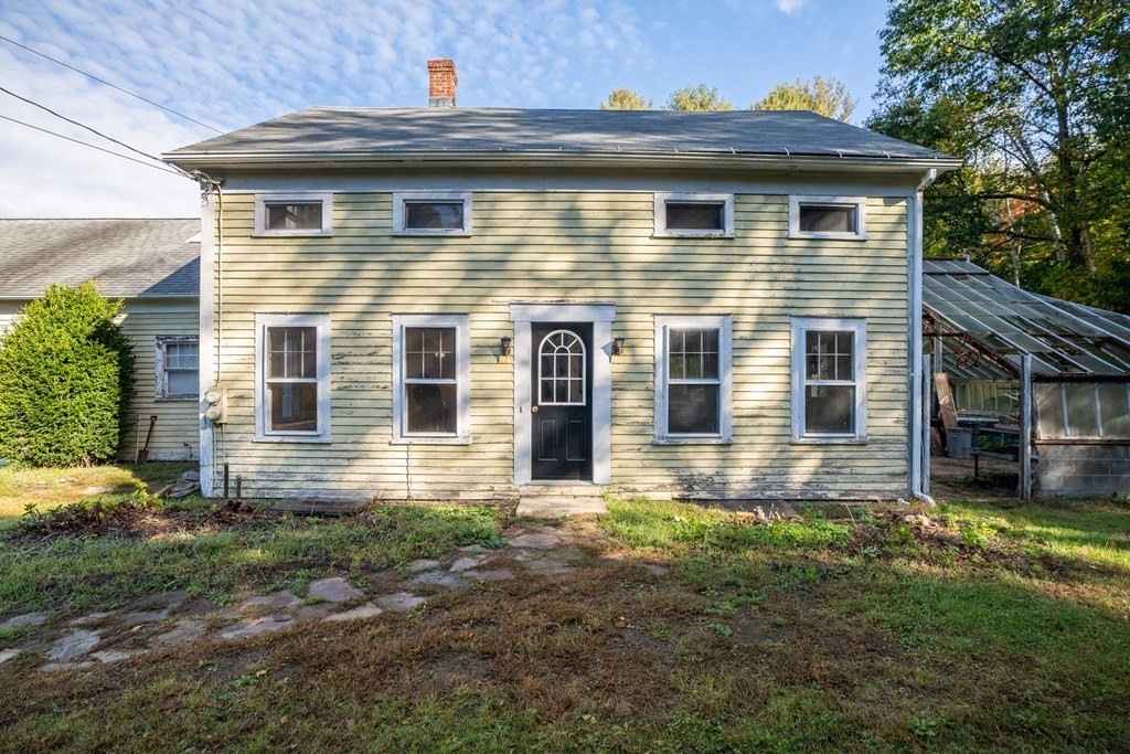 76 Amherst Road Pelham, MA 01002 - Photo 1 of 42 a view of a house with a yard and lawn chairs next to a yard