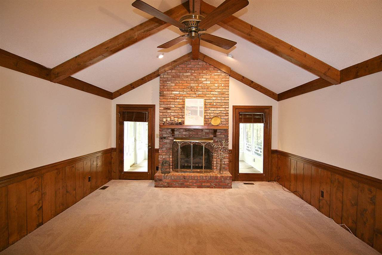 2816 Mattlyn Court Raleigh, NC 27613 - Photo 6 of 25 Xtra Large Living Room offers Lots of Space to Enjoy Life. Notice the Beautiful Brick Fireplace with Raised Hearth, Vaulted Ceiling with Beams -- Brand New Paint and Carpet. Living Room