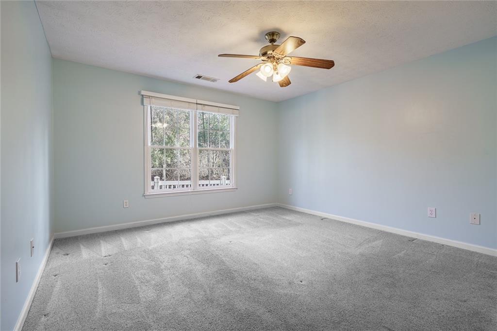 450 High Ridge Lane Dahlonega, GA 30533 - Photo 15 of 39 an empty room with windows and fan